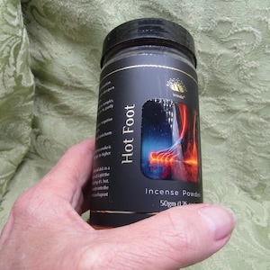 May include: A black cylindrical container of "Hot Foot" incense powder. The label features a colorful graphic of a foot with red and orange hues. The container holds 50g (1.76 oz) of incense powder.