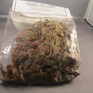May include: A clear plastic bag containing dried dandelion root, labelled "Diente de Leon" (Spanish for dandelion).