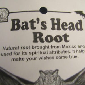 May include: A black and white image of a bat's head with the text "Bat's Head Root" and "Natural root brought from Mexico and used for its spiritual attributes. It helps make your wishes come true."