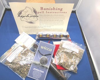 May include: A banishing spell kit with a variety of items, including dried herbs, incense, a silver pendant, and instructions. The kit is labeled "Banishing Spell Instructions" and "Azure Green".