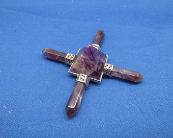 May include: Amethyst crystal pyramid with four points, each with a silver metal setting. The pyramid is purple and has a shiny finish.