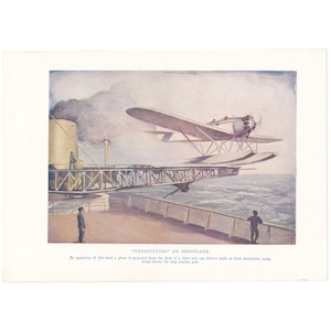 May include: A vintage illustration depicting a seaplane launching from a ship's deck via a catapult. The text reads: "CATAPULTING" AN AEROPLANE. By apparatus of this kind a plane is projected from the deck of a liner and can deliver mails.