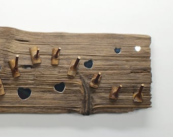 May include: Rustic wooden wall-mounted coat rack with heart-shaped cutouts and wooden pegs. The rack is made of weathered wood and features the text "Love the Nature & Save the Nature".