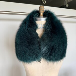 K&ouml;nnte beinhalten: Ein luxuri&ouml;ser, dunkelblauer Pelzkragen. Der Kragen wird auf einer Vintage-Schneiderpuppe pr&auml;sentiert. Das Fell wirkt weich und pl&uuml;schig, mit einer tiefen, satten Farbe. Der Kragen ist zum Tragen um den Hals konzipiert.