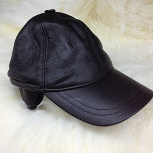 Real shearling - leather cap with ears and fur inside.