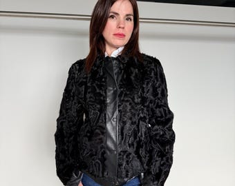 Black Swakara paw lamb fur with nappa dressed leather and snaps closure .Lightweight short Fur Jacket.