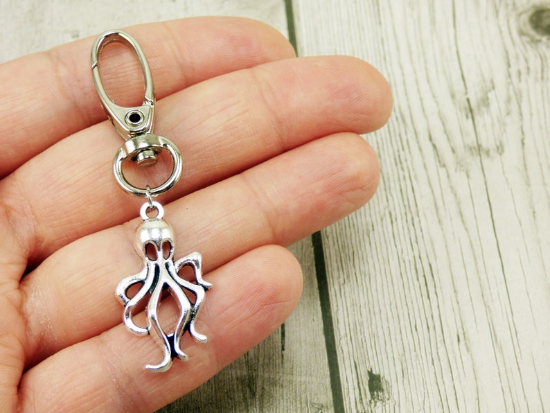 May include: Silver octopus keychain with a silver lobster clasp.