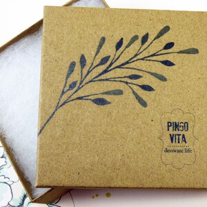 May include: A brown cardboard box with a blue floral design and the text "PINGO VITA decorate life". The box is open and has white tissue paper inside.