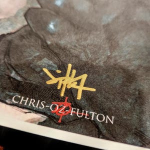 May include: A black and white image with a gold signature that reads "Chris-Oz Fulton" and a red Chinese character.