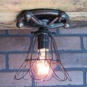 Vintage industrial flush mount ceiling light old cast iron gear with trouble cage