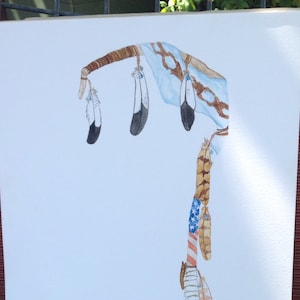 May include: A watercolor painting of a Native American dream catcher with brown feathers, blue and white beads, and a brown stick. The dream catcher is hanging from a brown branch.