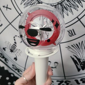 Bang Chan / Wolf Chan is placed on the flat side of the lightstick using black removable vinyl.