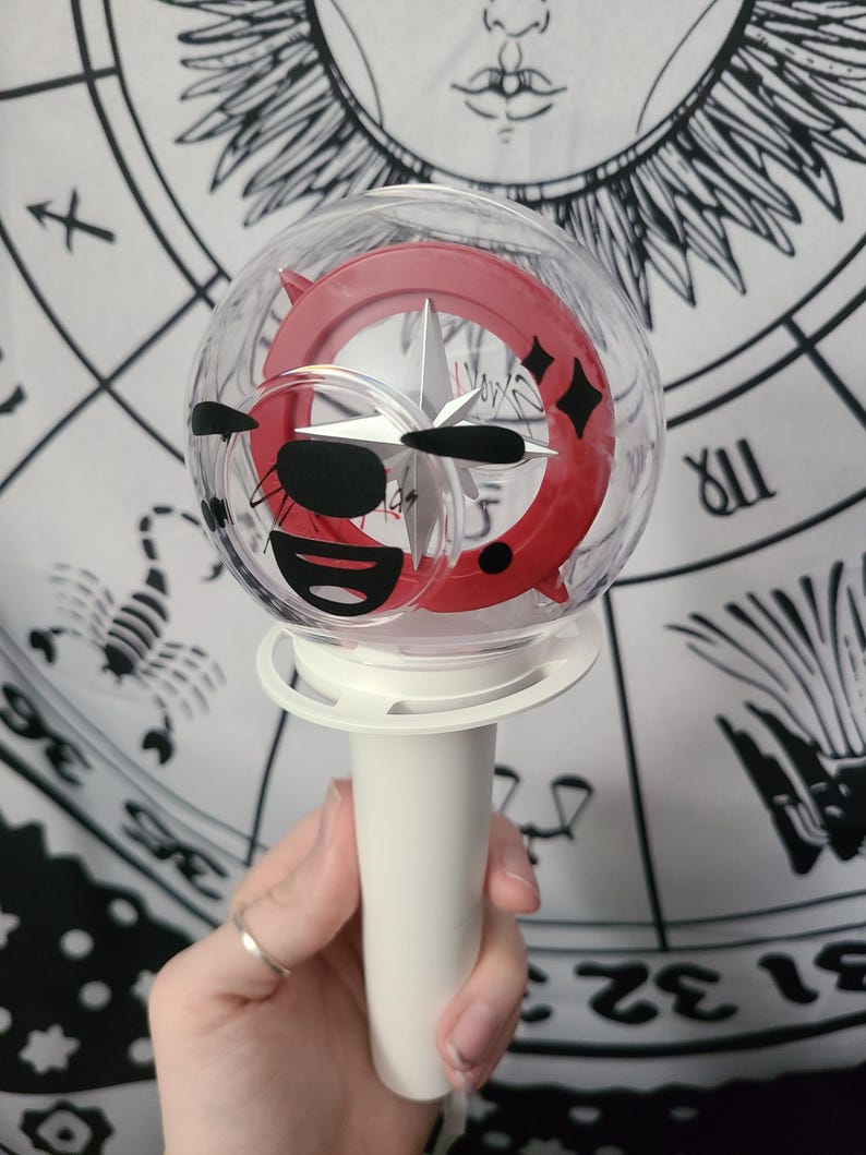 Bang Chan / Wolf Chan is placed on the flat side of the lightstick using black removable vinyl.