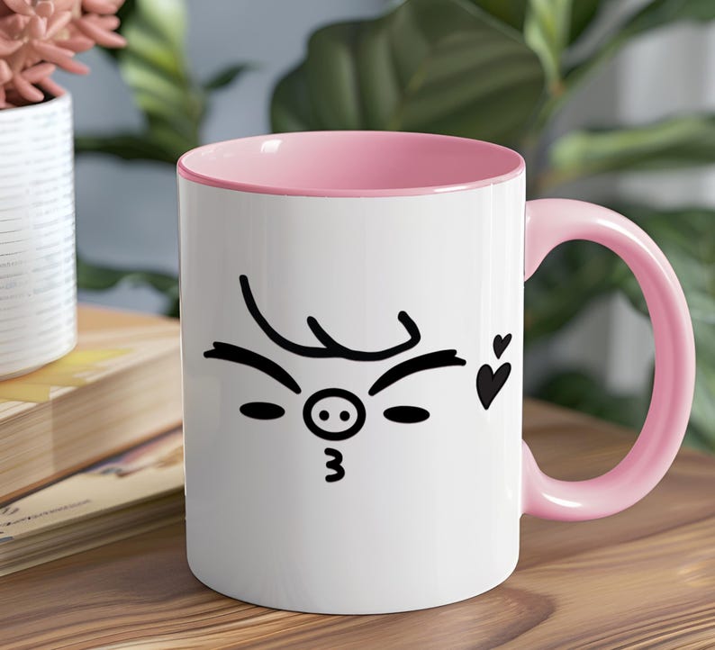 May include: White ceramic mug with a pink rim and handle. The mug features a black and white illustration of a pig face with a winking eye and a heart.