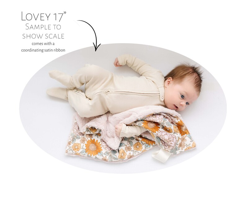 May include: A baby lying on a white background with a floral patterned blanket. The blanket is 17 inches and comes with a coordinating satin ribbon. "Lovey 17" is written on the image.