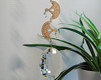 Hanging crystal suncatcher, unusual and ornate. Created to be something different in style. Big crystal prism plus interesting shadows.