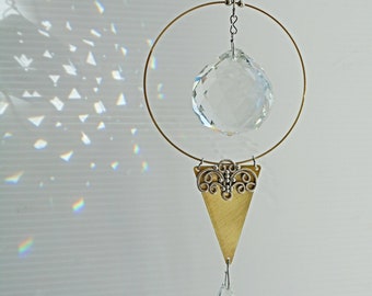 Minimalist suncatcher with brass accents. Handmade crystal ball hanging.  Big rainbow maker and window feature. Elegant sparkling crystal.