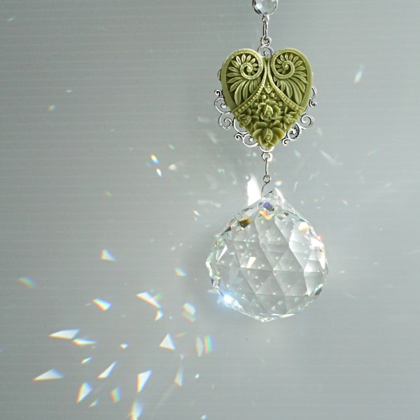 Crystal ball sun catcher in a cottage style heart theme. Large round prism with ornate hearts in mixed colours. Deluxe hanging décor.