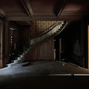 Chiaroscuro photography of stairs in an abandoned castle in France