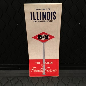 May include: A vintage road map of Illinois and the United States, featuring a red diamond-shaped sign with the text "D-X" in white. The sign is on a white pole with the text "The Sign of Friendly Service" in red and white.