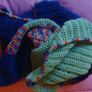 May include: A blue, green, and multi-colored crocheted blanket with a textured pattern.