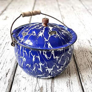 May include: A set of three ceramic mugs with a speckled, matte finish. The mugs are in shades of cream, light gray, and dark gray. Each mug has a simple, minimalist design and a rounded handle.