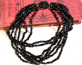 It's quite fetching - Multi Strand Jet Black Beaded Mid Century Necklace Vintage - 7 Strand Chunky Choker Style - Decorative Round Closure