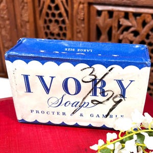 May include: A vintage Ivory Soap box with a blue and white design. The box features the words "IVORY Soap" in a bold font, with "Procter & Gamble" below. The box has a scalloped edge and the words "LARGE SIZE" are printed on the top.