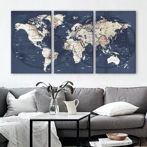 May include: A three-piece canvas wall art set featuring a vintage-style world map in shades of blue and beige. The map is divided into three sections, each with a different continent. The map is surrounded by a dark blue border.