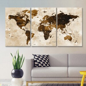 May include: A three-piece canvas wall art set featuring a vintage-style world map with brown and beige tones. The map is printed on a textured canvas and has a distressed look. The map is divided into three sections, each with a different continent. The map is framed in a simple black frame.