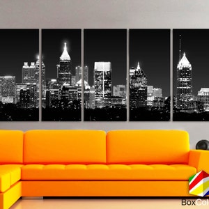May include: Black and white cityscape photograph of a city skyline at night. The image is split into five panels, showing a variety of buildings, including skyscrapers, and a view of the city from a distance.