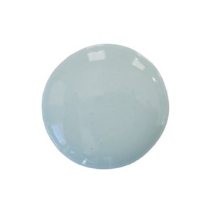 May include: A light blue, round, smooth, and glossy paint sample.