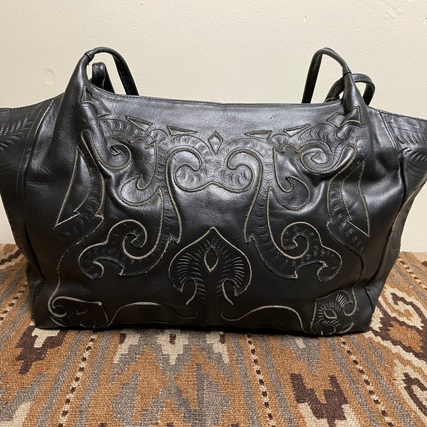 Leaders In Leather, Shoulder Bag New, Never Used, Tag On. Beautifully Cutout Tooled Shoulder Bag, Excellent quality Color: Black