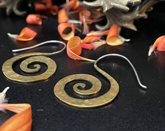 Frame your face with these lovely brass spirals. Swirls of brass have a beautiful dimension that elegantly curves and tapers at the end.