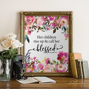 May include: A framed print with a watercolor floral design and the quote "Her children rise up & call her blessed" with the scripture reference "Proverbs 31:28".