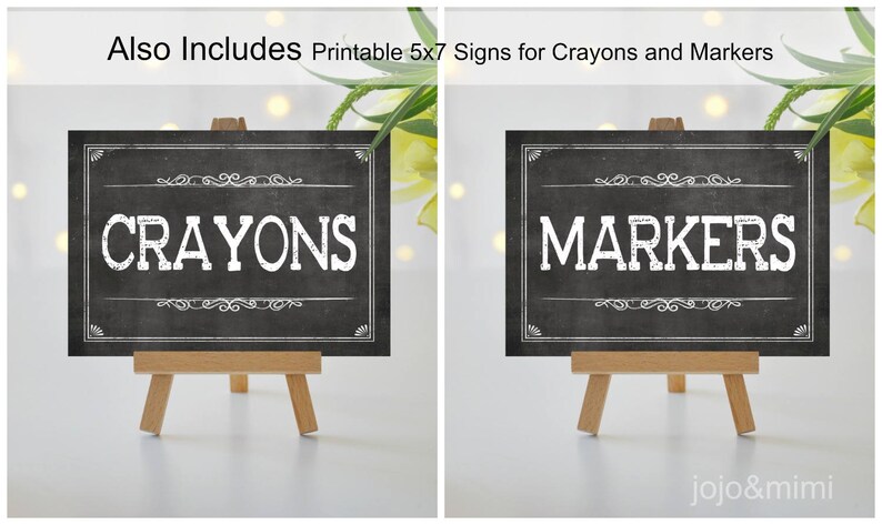 May include: Two black chalkboard signs with white text on wooden easels. The sign on the left says "Crayons" and the sign on the right says "Markers".