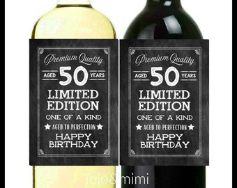 May include: Two wine bottle labels with a chalkboard design. The labels say "Premium Quality Aged 50 Years Limited Edition One of a Kind Aged to Perfection Happy Birthday".