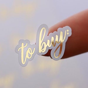Pegatinas de planificador con la palabra "Comprar" en lámina dorada: escritura elegante, vinilo resistente al agua