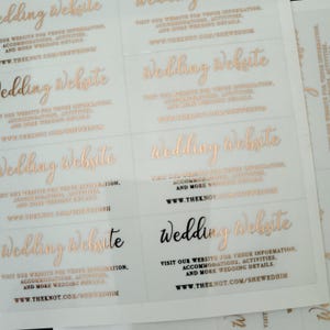Transparent sticker with gold foiled text print.  Wedding Website is written at the top. Below the text reads: visit our website for venue information, accommodation, activities, and more wedding details. At the bottom is your wedding website link.