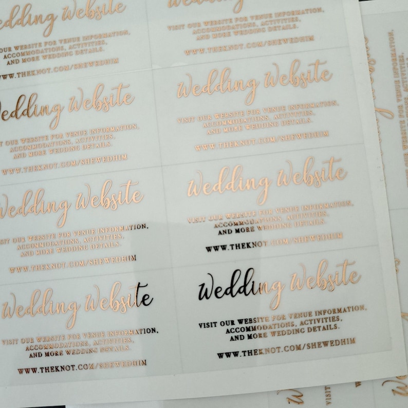 Transparent sticker with gold foiled text print.  Wedding Website is written at the top. Below the text reads: visit our website for venue information, accommodation, activities, and more wedding details. At the bottom is your wedding website link.