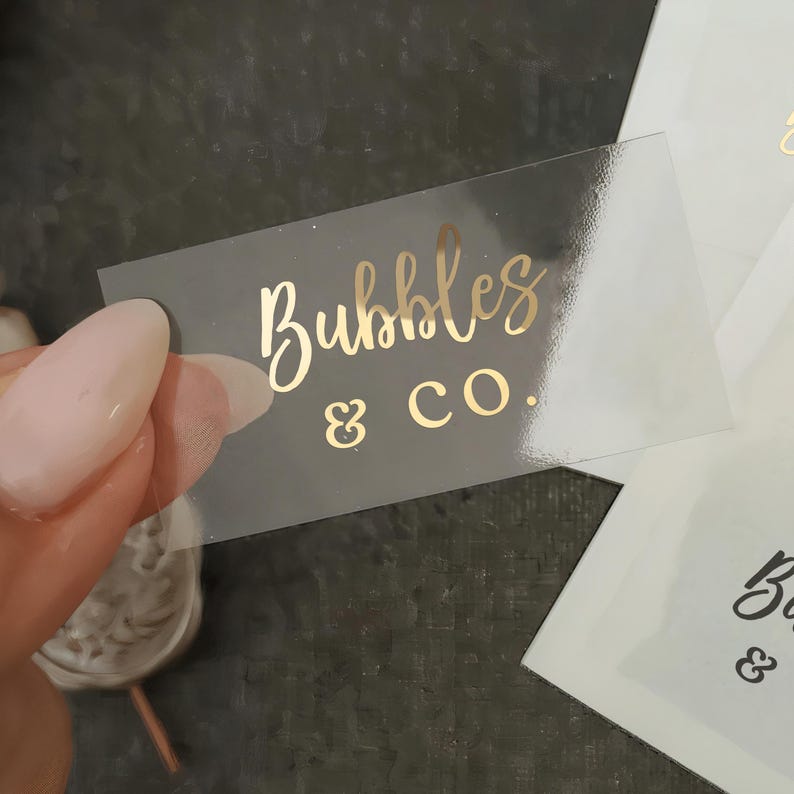 May include: A clear sticker with gold lettering that reads "Bubbles & Co."