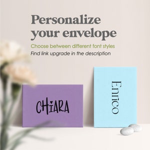 May include: A purple envelope with the name CHIARA printed in black and a light blue envelope with the name Enrico printed in black. Text above reads: Personalize your envelope, Choose between different font styles, Find link upgrade in the description.