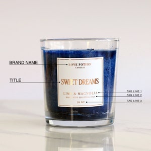 white glossy candle sticker with gold foiled print in square shape, placed on a handmade blue candle