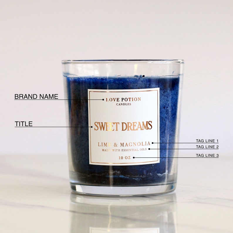white glossy candle sticker with gold foiled print in square shape, placed on a handmade blue candle