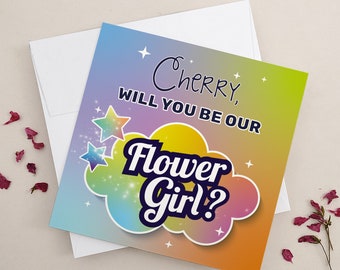 Könnte beinhalten: Eine bunte Karte mit einem Regenbogenhintergrund und Sternen. Die Karte sagt "Cherry, willst du unser Blumenmädchen sein?" in einer verspielten Schrift.