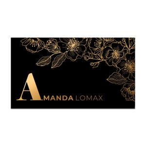 Black velvet business cards with a gold foil print. The design features gold floral decoration as a background. At the bottom in gold foiled print is written your name or business name.