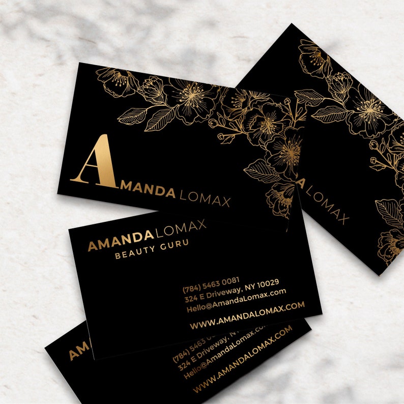 Black velvet business cards with a gold foil print. The design features gold floral decoration as a background. At the bottom in gold foiled print is written your name or business name. At the back the card is black with your personal details in gold
