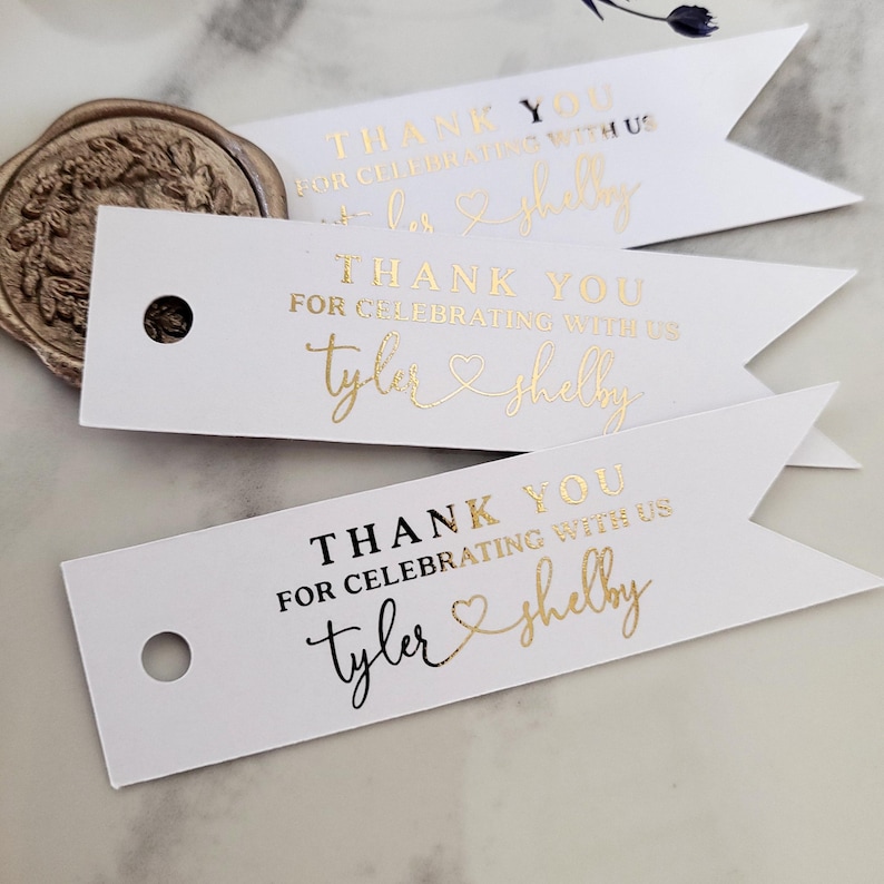 XOXOKristen gold foil Heart Connected Wedding Favor Tags featuring “Thank you for celebrating with us” and connected names with a heart symbol, printed on crisp white card — perfect for elegant wedding favors.