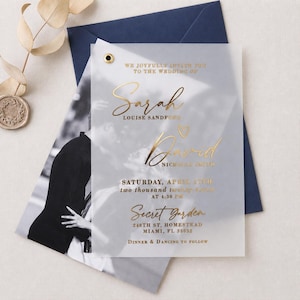 May include: A translucent wedding invitation with gold foil text featuring the names Sarah Louise Sandford and David Nicholas Smith, date April 17th, and location Secret Garden, Miami, FL, layered over a black and white photograph in a navy envelope.