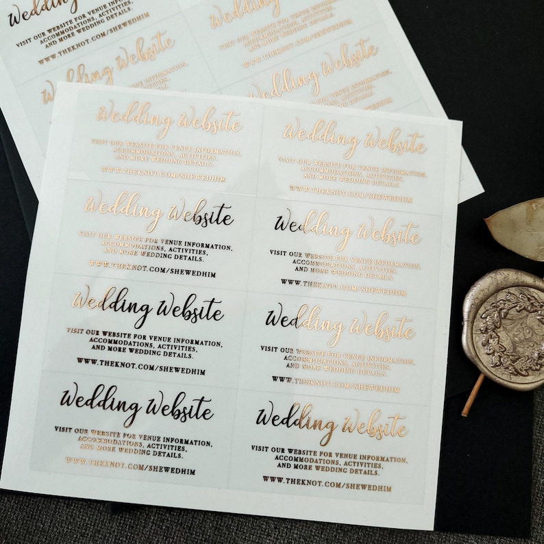 Transparent sticker with gold foiled text print.  Wedding Website is written at the top. Below the text reads: visit our website for venue information, accommodation, activities, and more wedding details. At the bottom is your wedding website link.